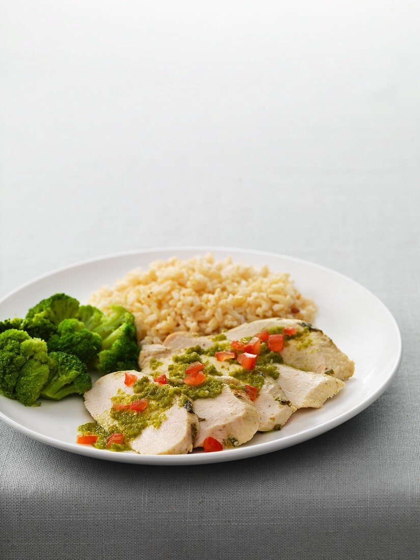 Chicken breast fillets with salsa verde, broccoli, and rice