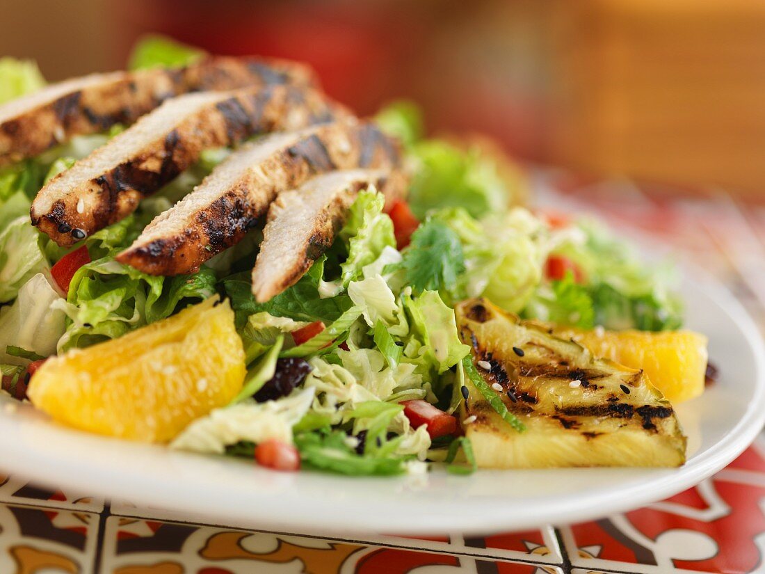 Caribbean salad with grilled chicken breast and pineapple