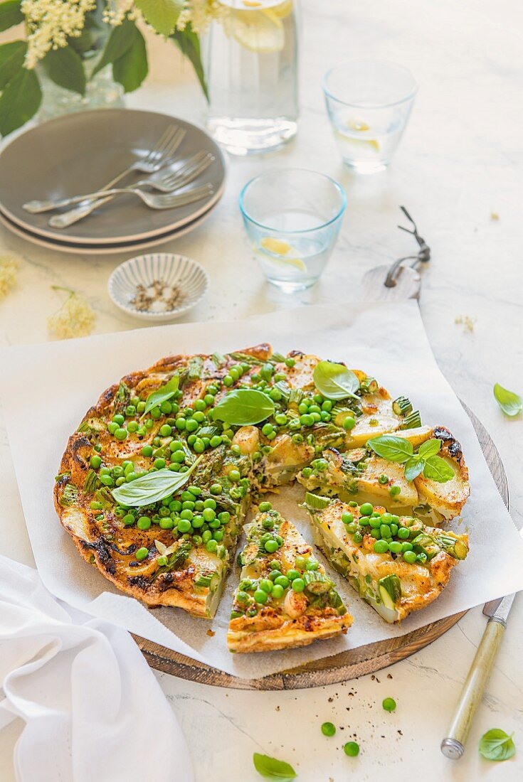 Asparagus and pea summer frittata with freah basil leaves