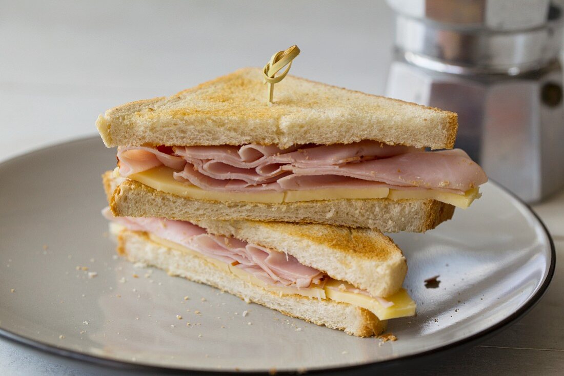 Toasted ham and cheese sandwich, halved