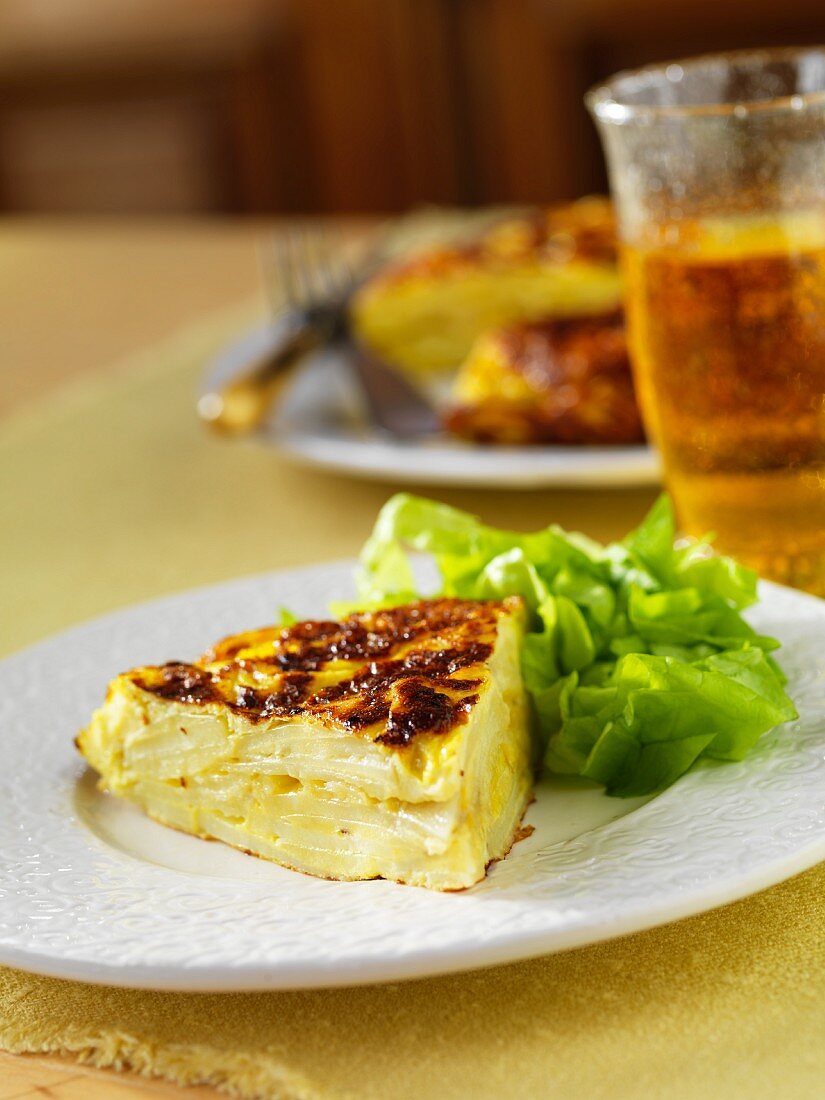 A slice of frittata with lettuce leaves