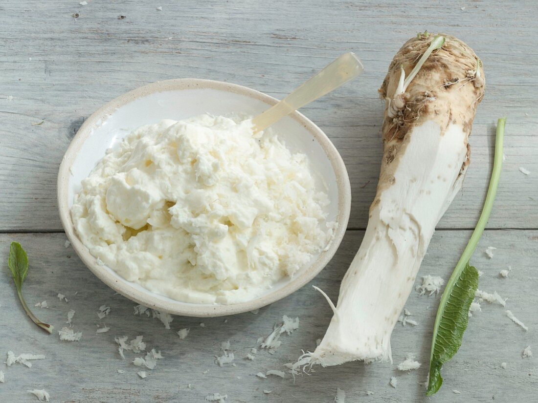 A horseradish root, horseradish cream, and a horseradish leaf