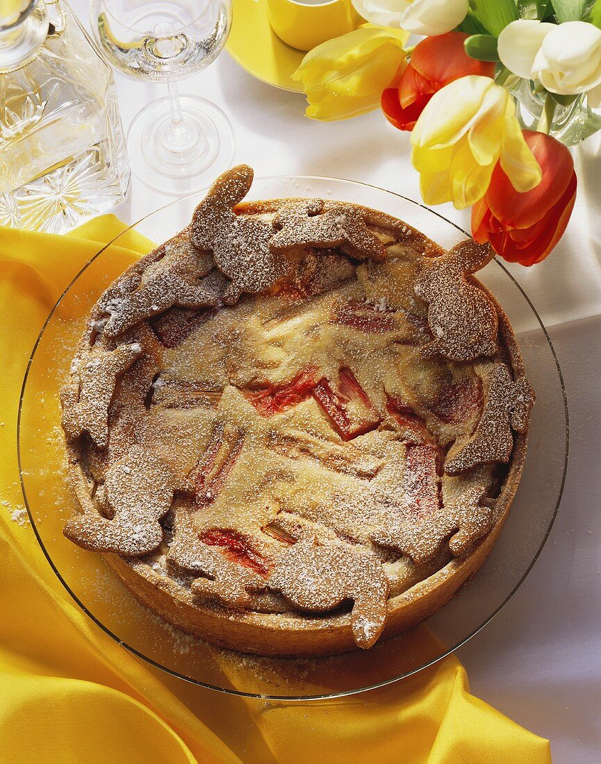 Rhubarb cheesecake decorated with pastry Easter bunnies