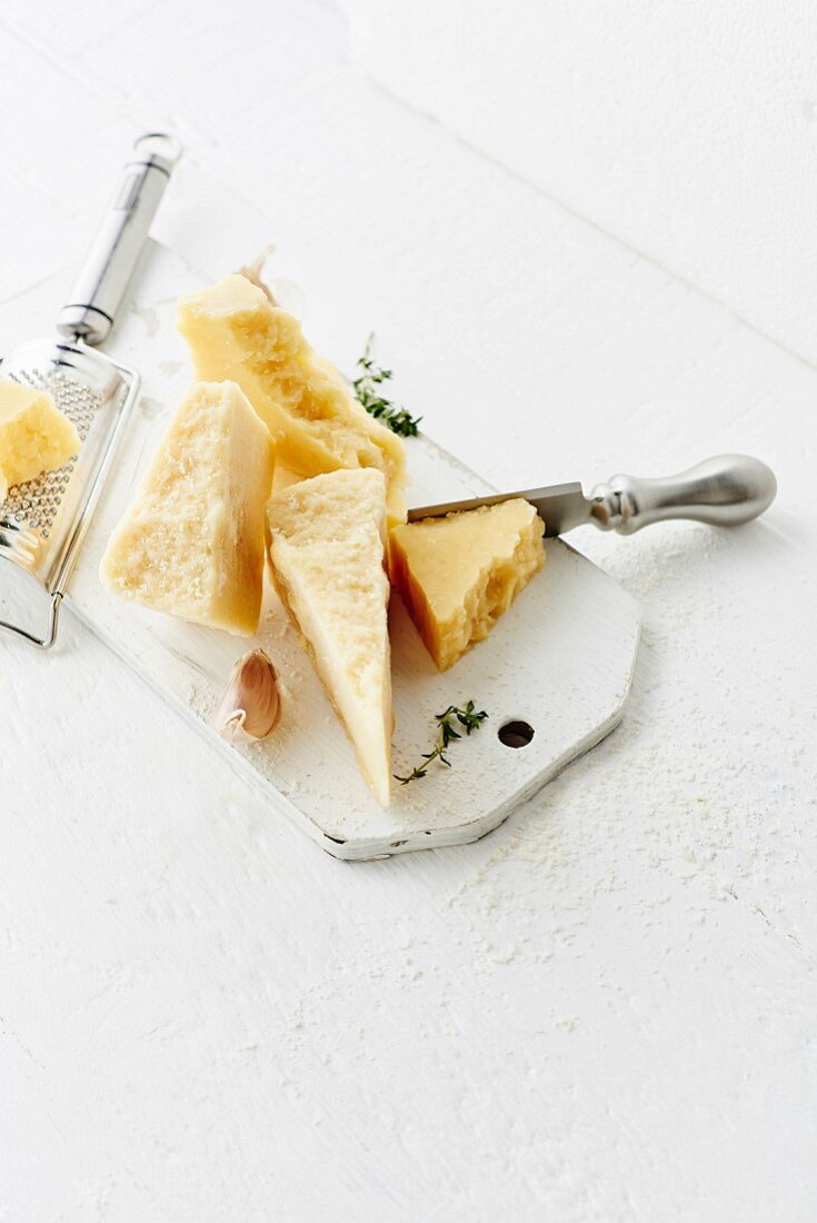 Still life of Parmiggiano-Reggiano and herbs
