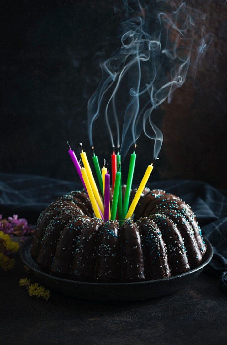 A vegan gugelhupf with extinguished birthday candles