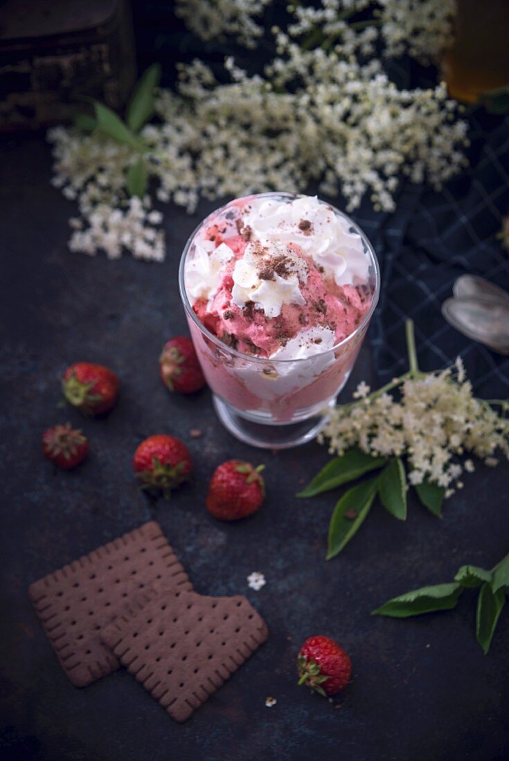 Strawberry ice cream with soy cream, elderberry syrup, and biscuit crumbs