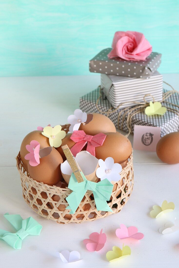 Blown eggs decorated with paper flowers and paper bows in Easter basket
