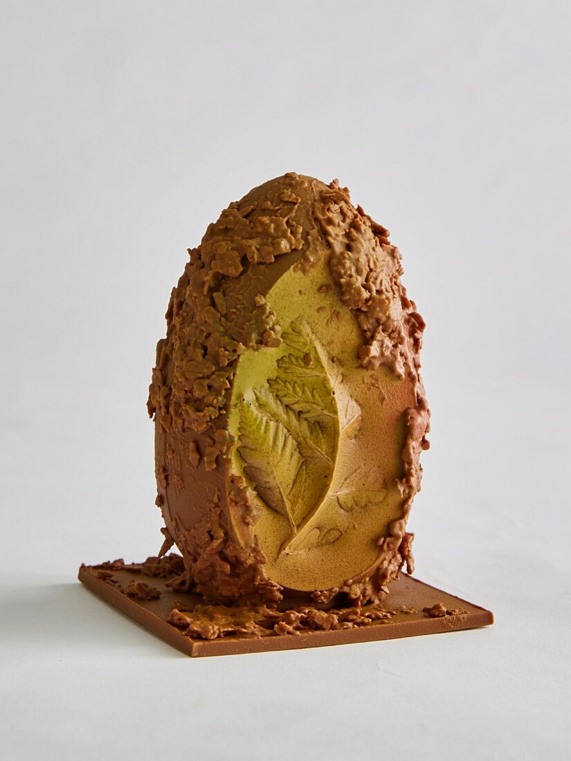 Chocolate egg with irregular surface and leaf relief