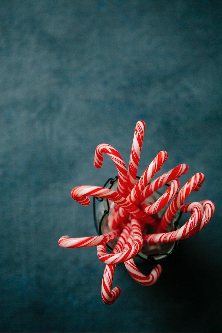 Several candy canes in a container