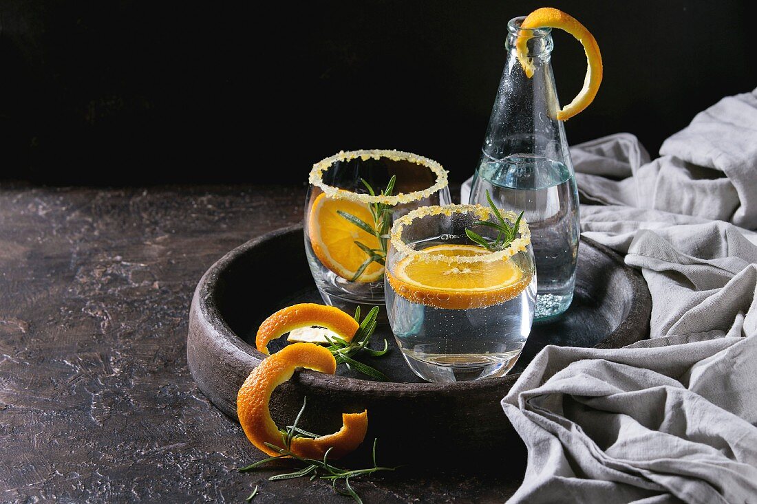 Tonic water cocktail with rosemary and orange