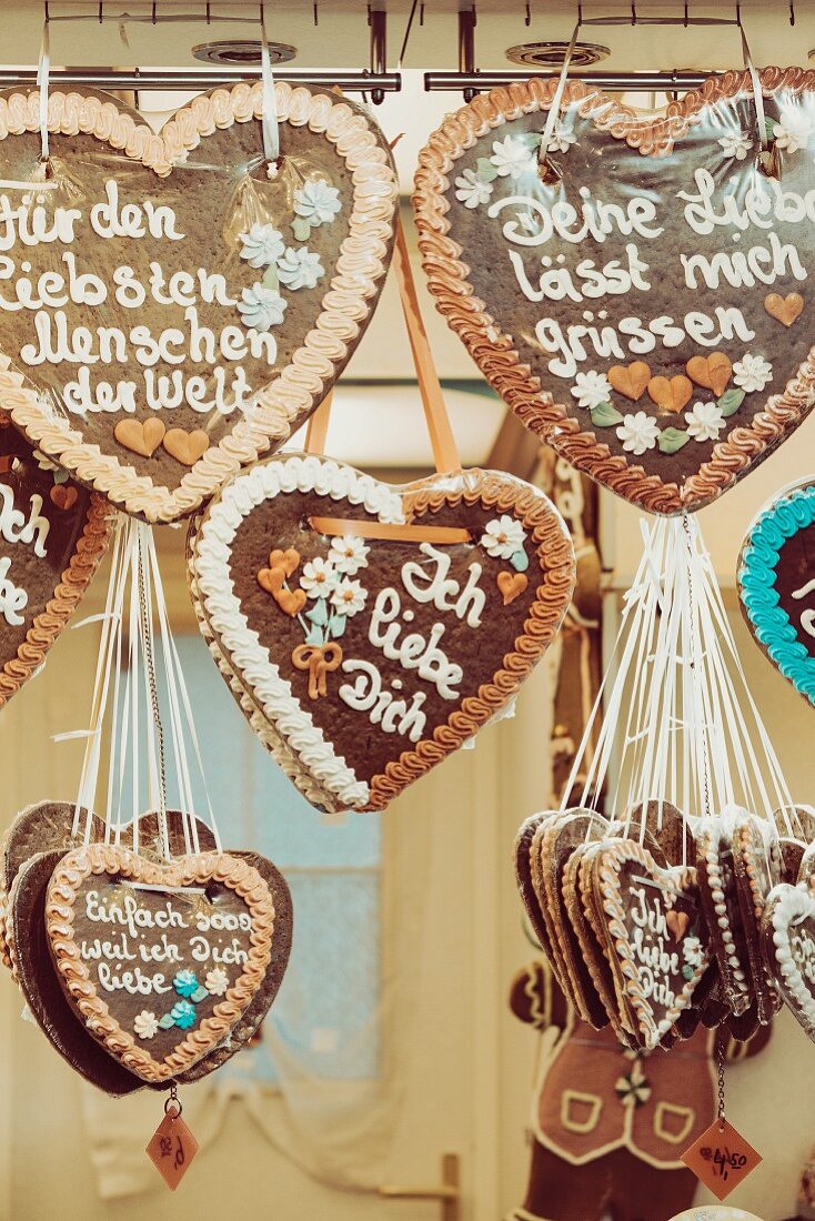 Gingerbread hearts hanging for sale at a market stand