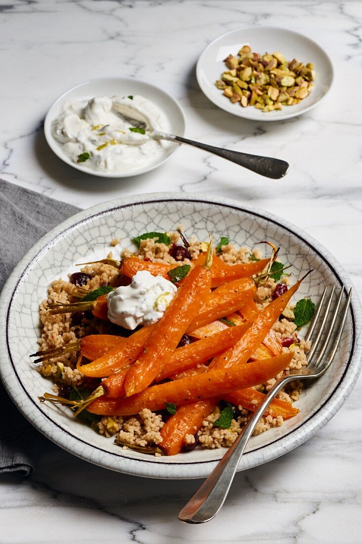 Oven roasted carrots with couscous, mint, pistachios, cranberries and a lime and yogurt dip