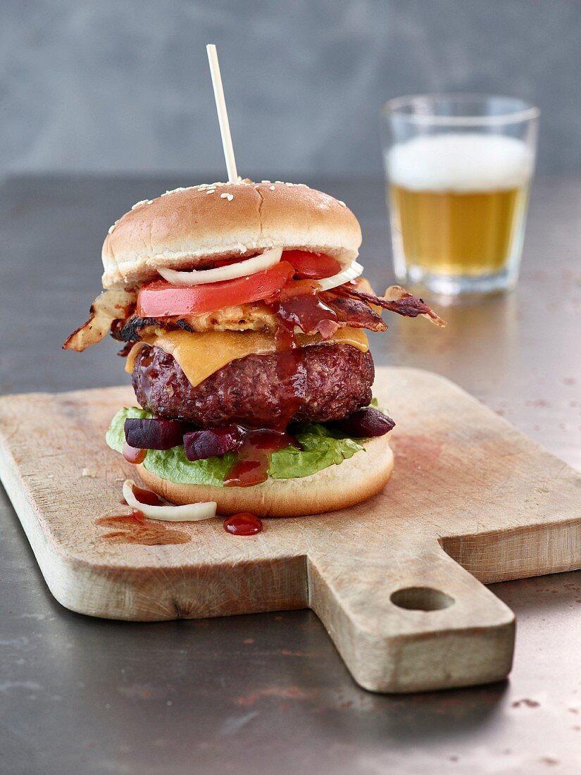 A beef burger with cheddar, bacon and BBQ sauce