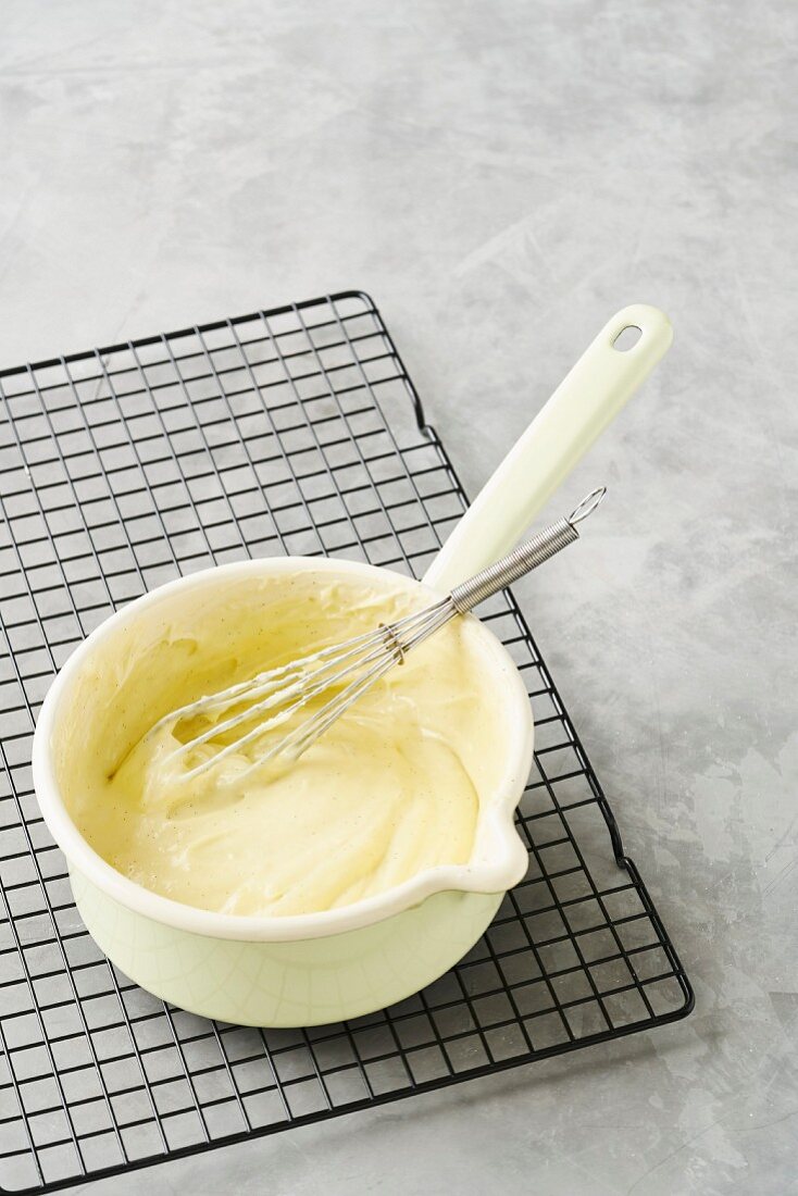 Whipped vanilla cream in an enamel pot