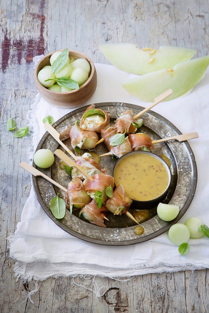 Parma ham and melon skewers with a honey and mustard dip