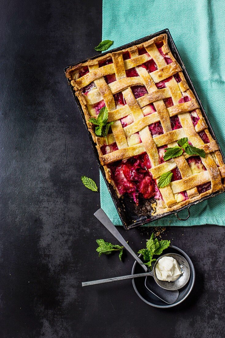 Sour cream and plum pie with a dough lattice