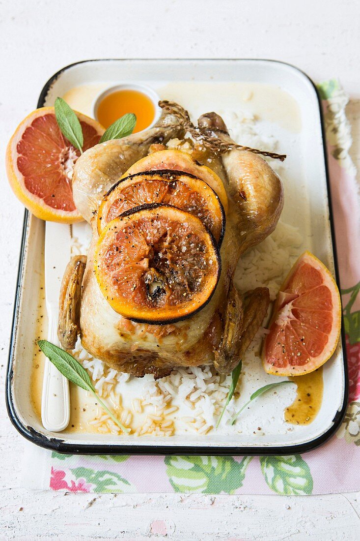 Roast chicken with a citrus glaze, stuffed with grapefruit and sage