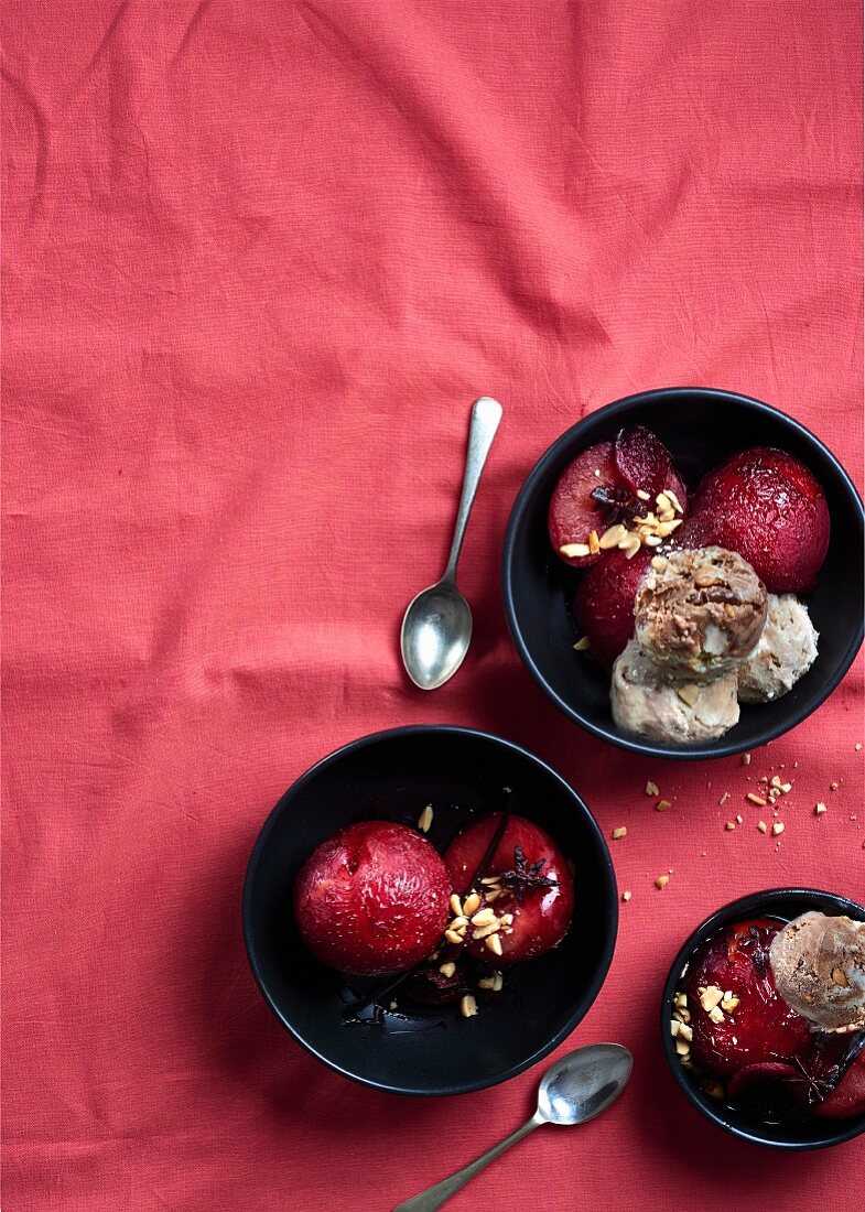 Plums poached in red wine and ginger syrup with nut ice cream
