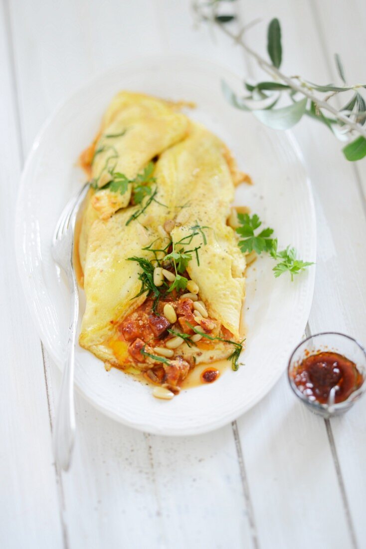 Omelette stuffed with pine nuts and herbs