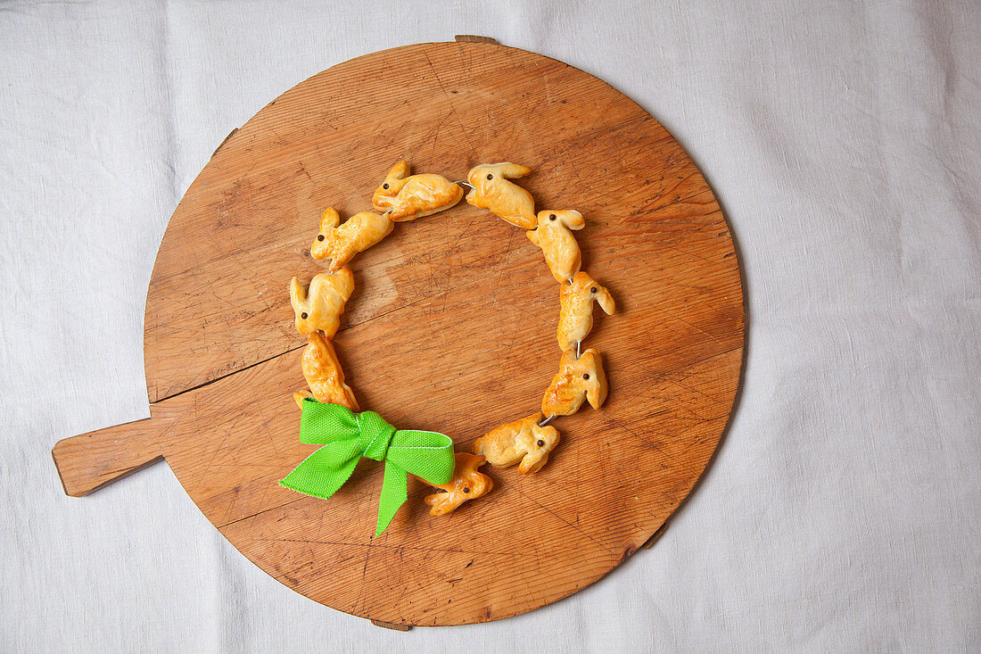 Wreath of pastry bunnies on round chopping board