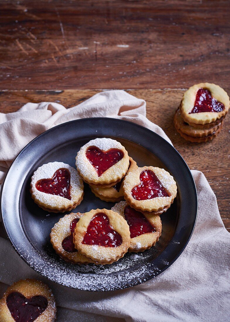 Vanilla biscuits with heart cut outs, filled with raspberry jam