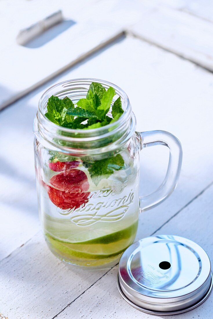 Water infused with limes, strawberries, and mint