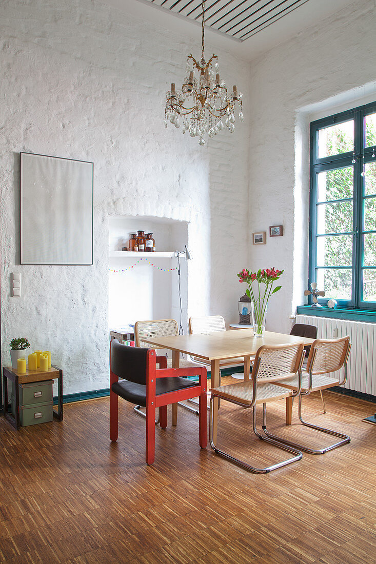 Vintage furniture in dining room with high ceiling and parquet floor