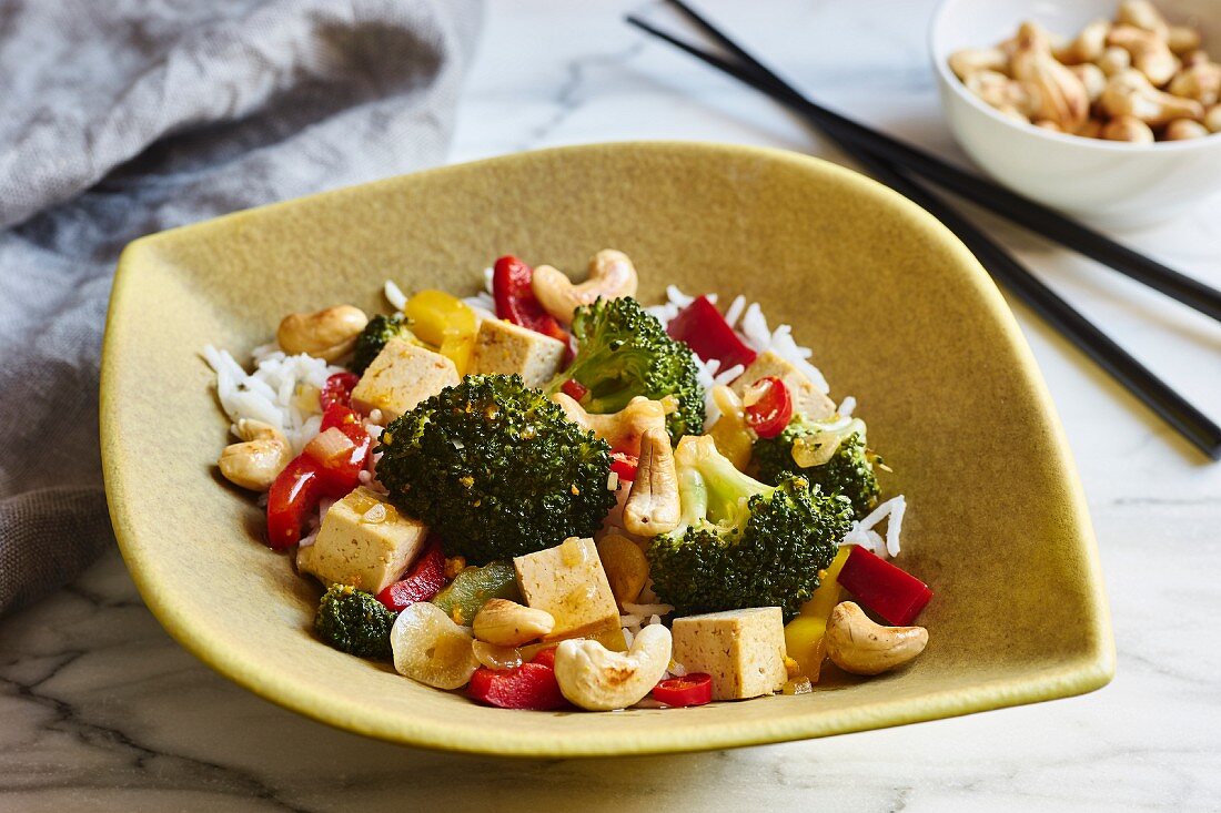 A vegetarian wok dish with broccoli, peppers, chili and cashews