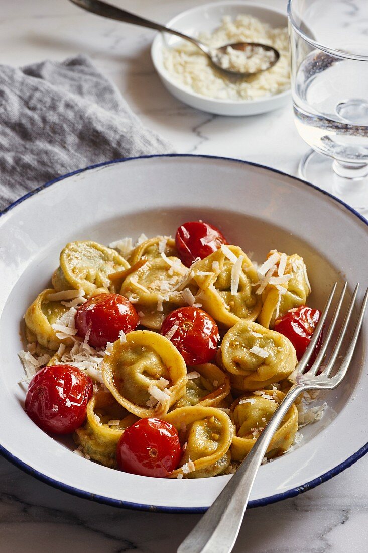 Homemade spinach and ricotta tortellini with cherry tomatoes