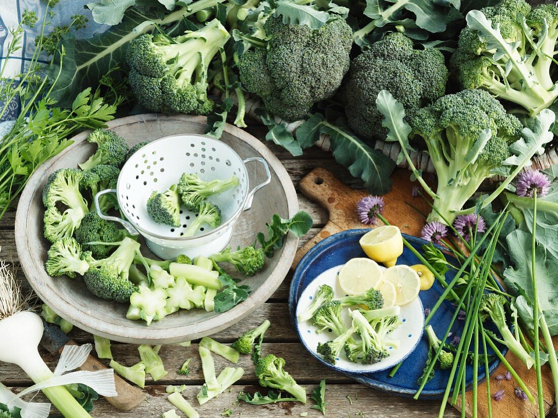 A still life with broccoli, lemon, garlic and chives