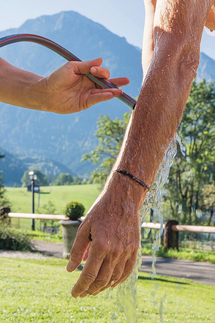 A Kneipp water jet on the arm at the Prinz-Luitpold-Bad spa hotel in Bad Hindelang in the Allgäu region of Germany