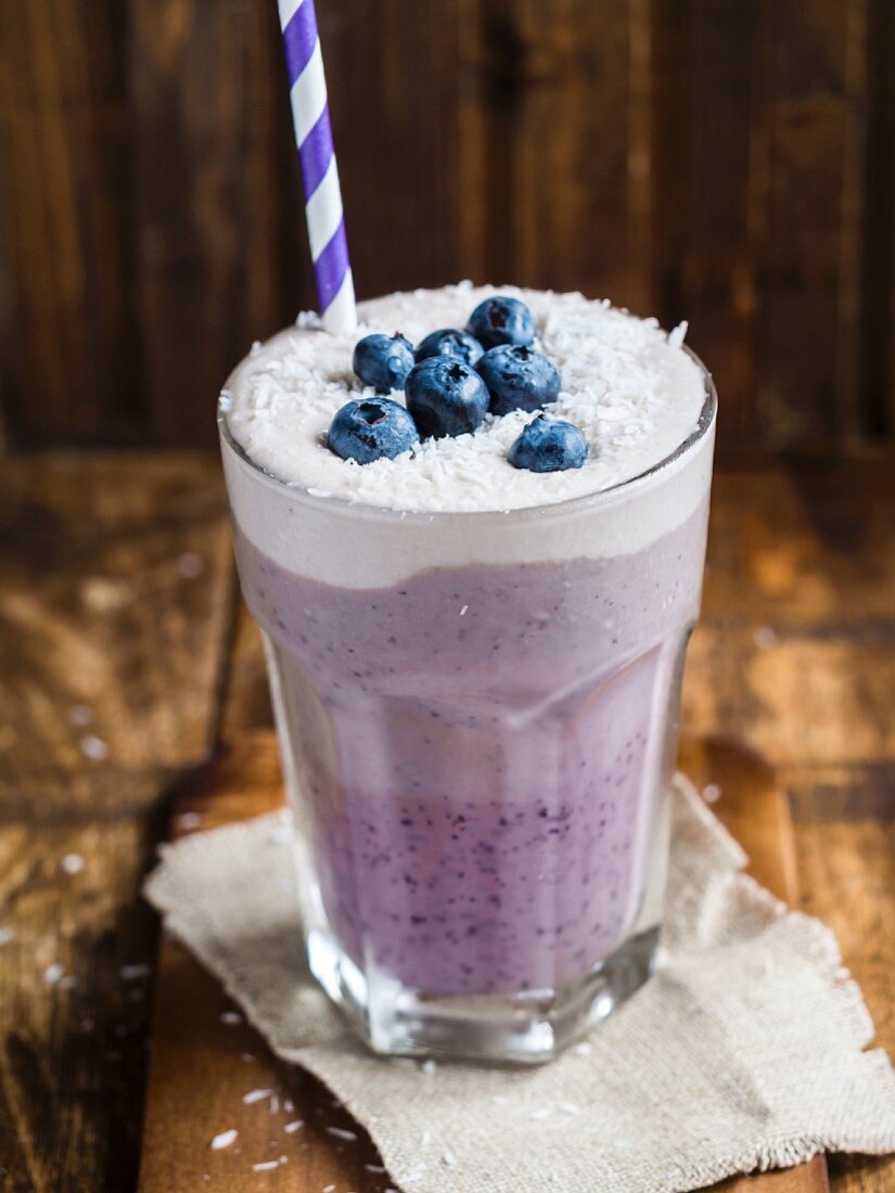 Vegan layered blueberry smoothie with coconut cream