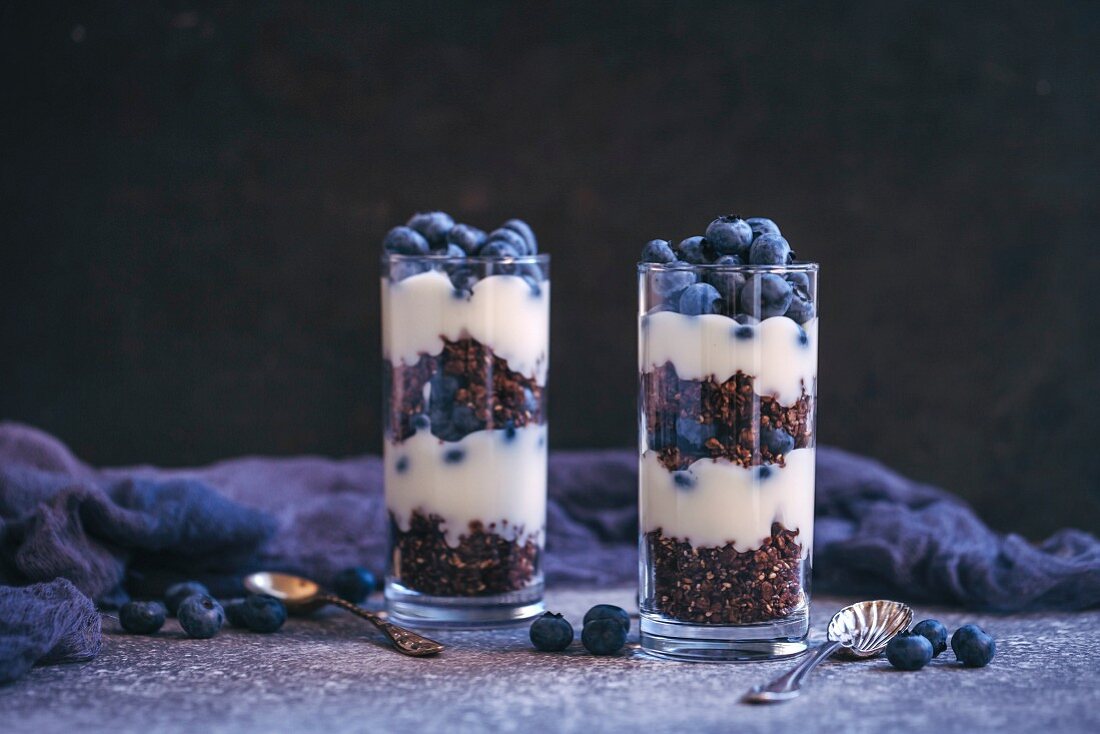 Granola, yogurt and blueberries parfaits in glasses