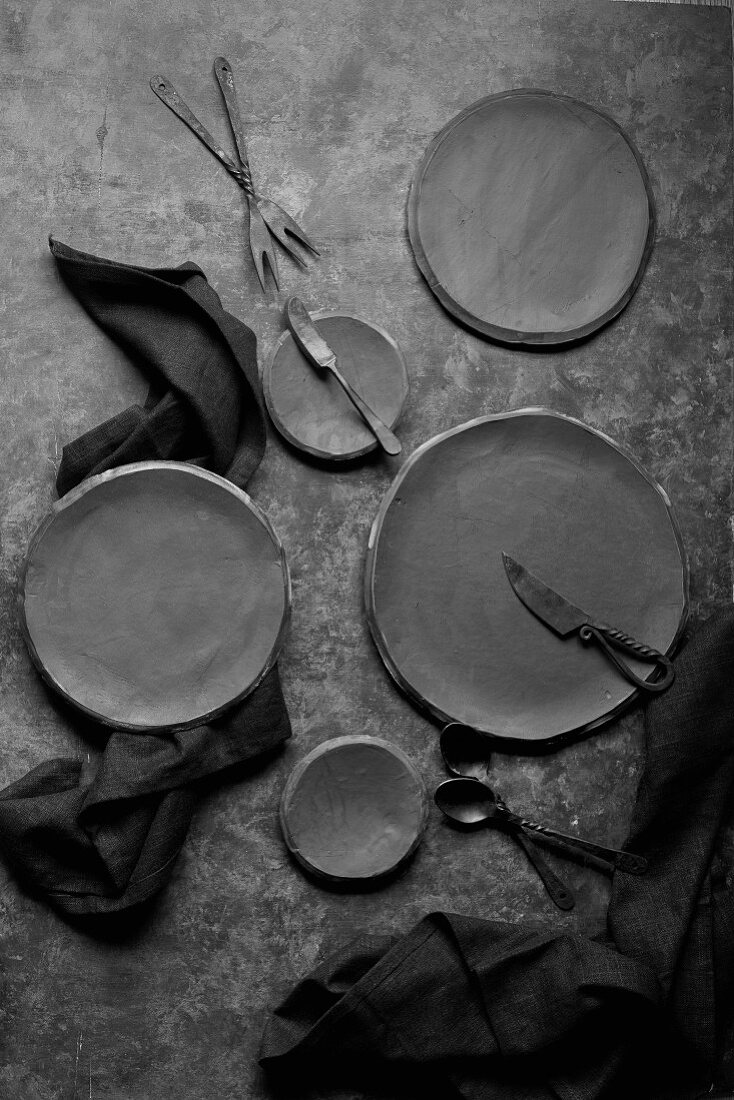 Black plates and cuttlery on a black table