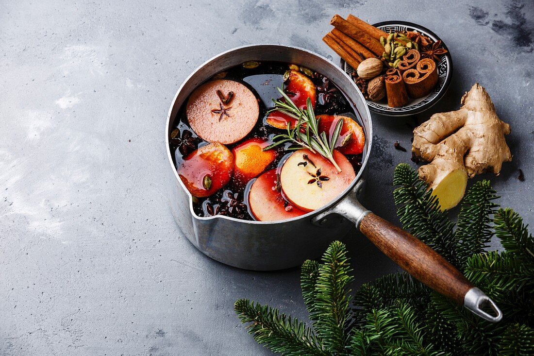 Mulled wine hot drink with citrus, apple and spices