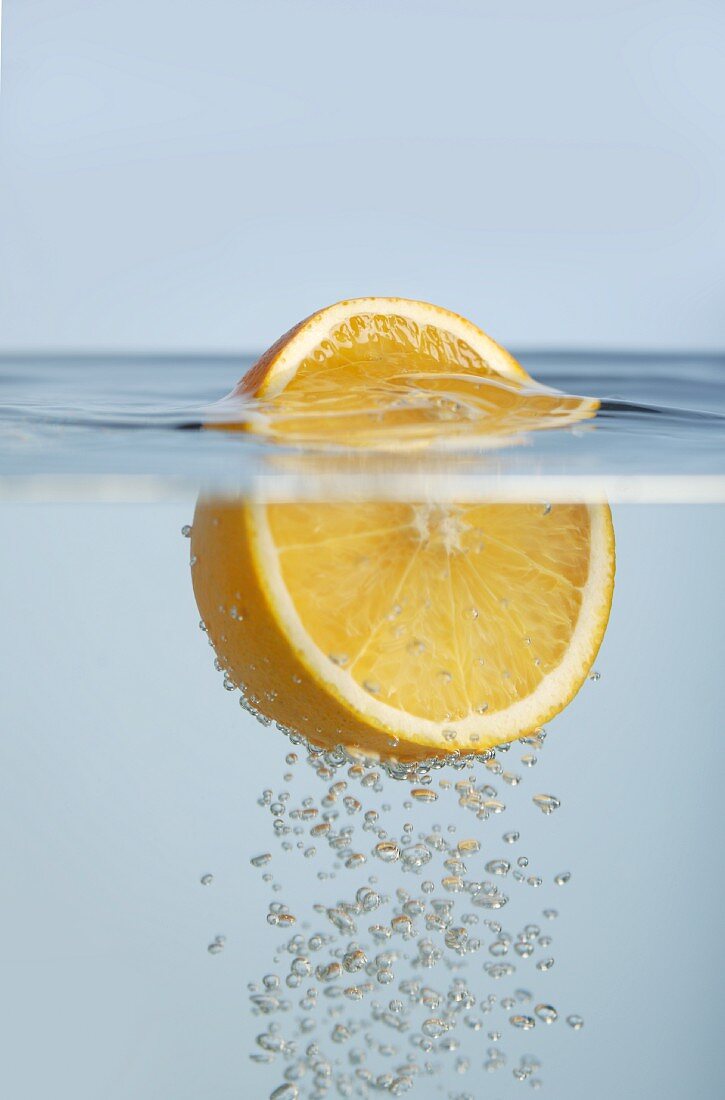 Half an orange floating in water