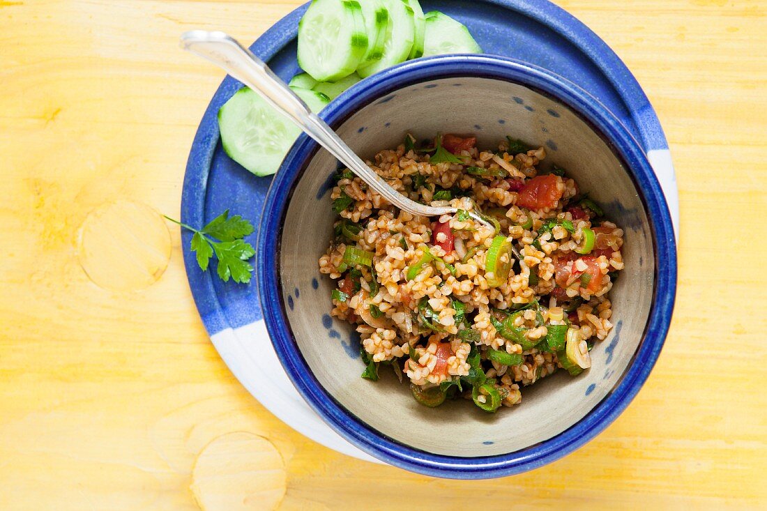 Bulgur wheat salad with onions, tomatoes, mint and pomegranate syrup