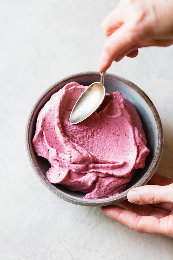 A smoothie bowl with hibiscus and cashew butter