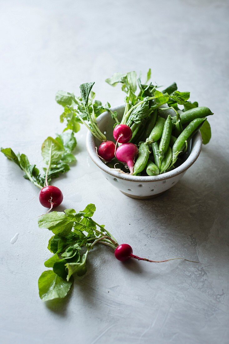 Raddishes and peas in a bowl