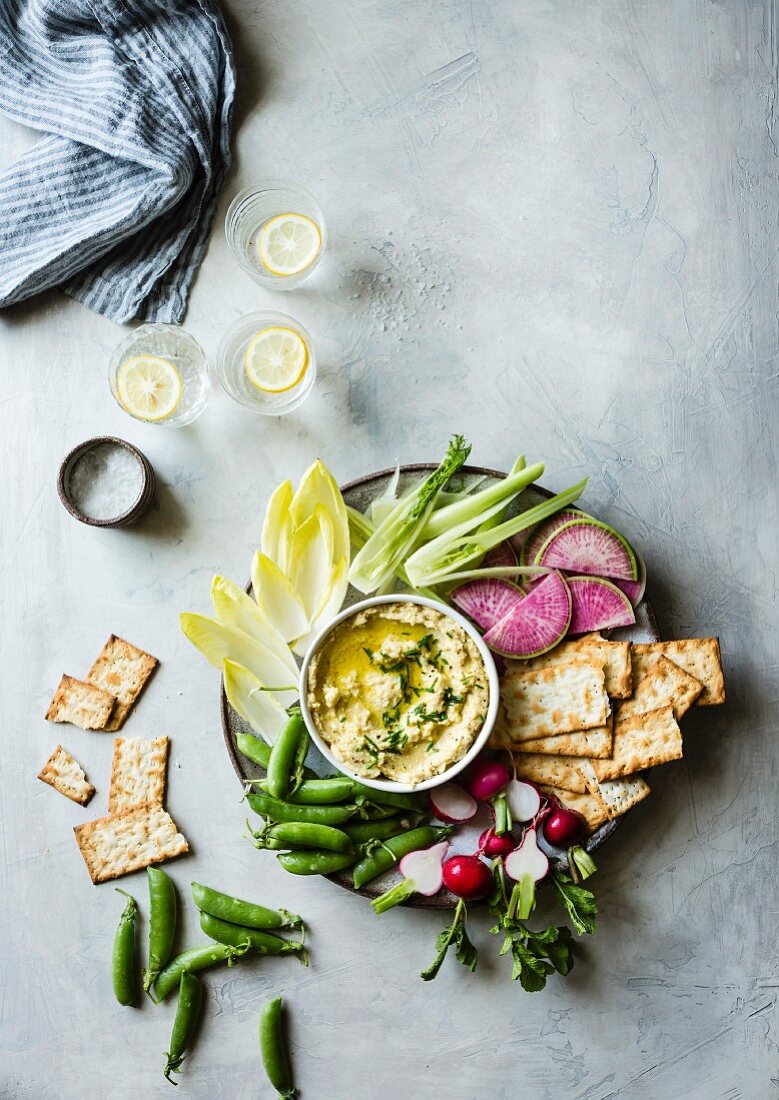 Spring vegetables and hummus on a platter