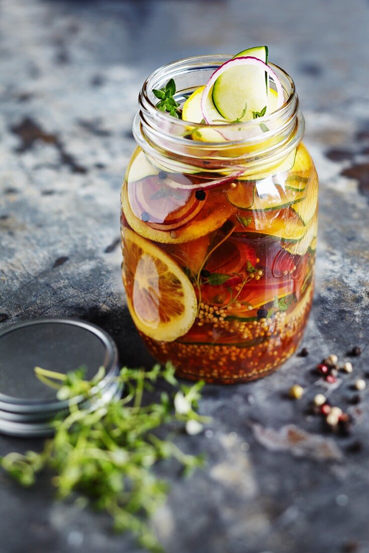 Sweet and sour pickled courgettes in a glass jar