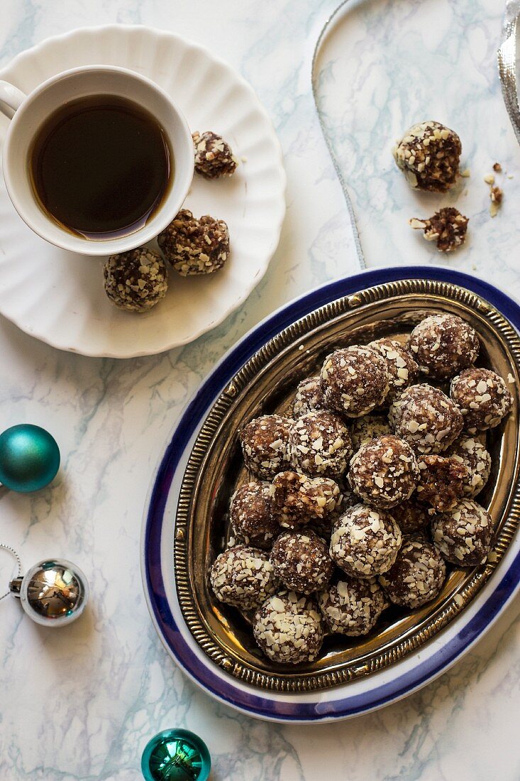 Dates and almond truffles, no sugar, cup of coffee, Christmas decorations