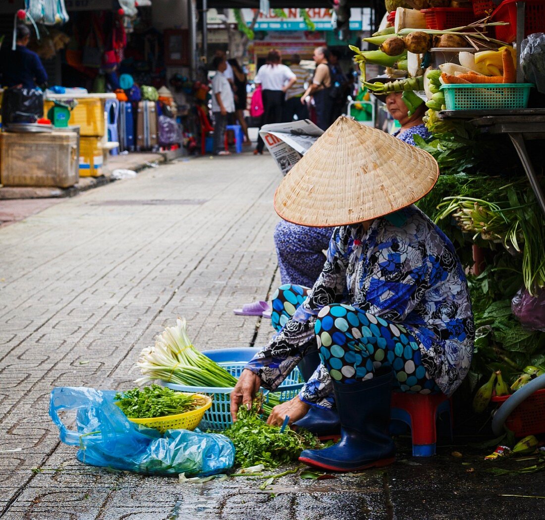 A street market seller in Ho Chi Minh City, Vietnam