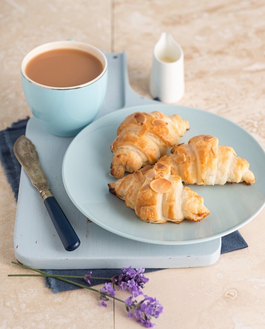 Croissants with almond flakes, served with tea