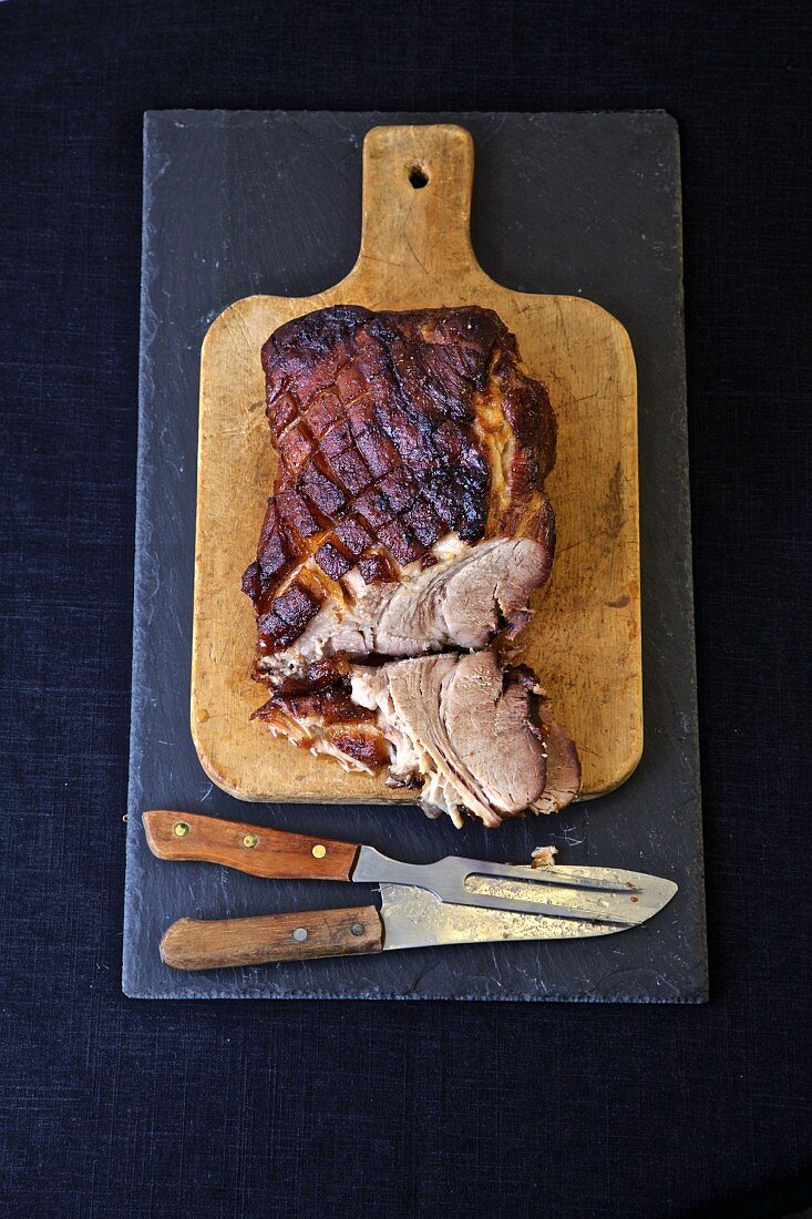 Sliced roast pork on a wooden board