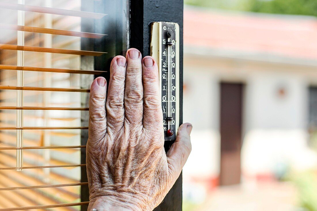 Elderly person checking the temperature