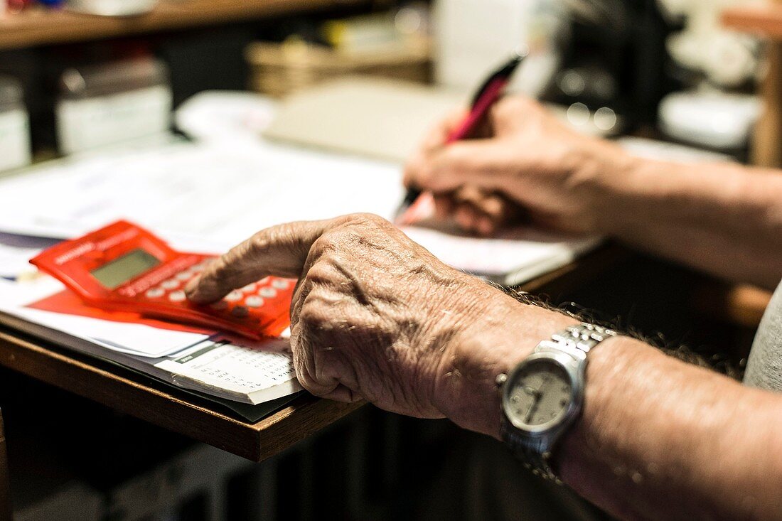 Elderly man calculating finances