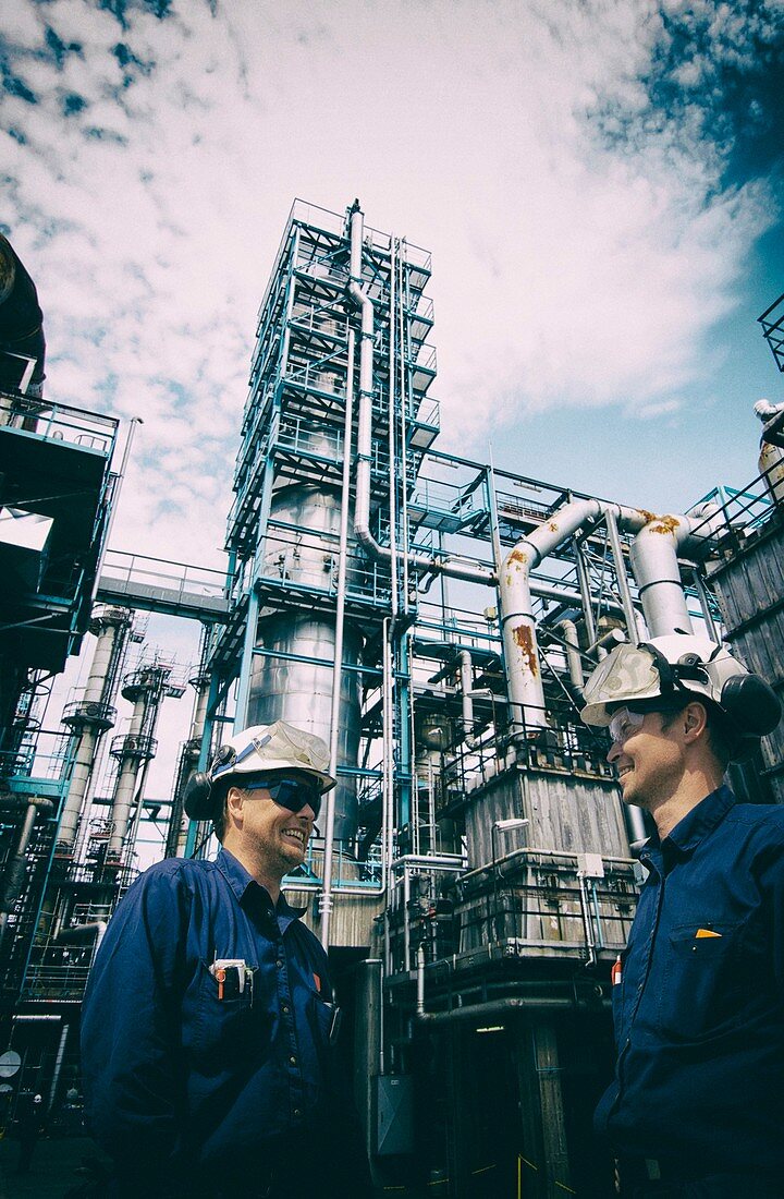 Two industrial workers on oil and gas refinery