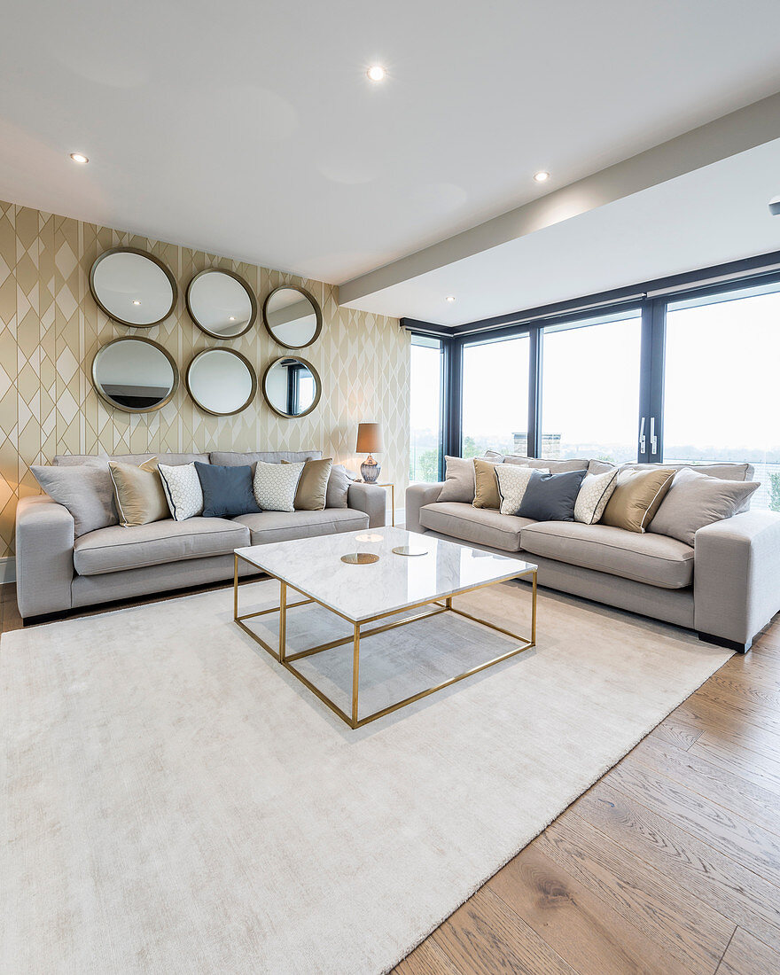 Glamorous living room in shades of Champagne with glass wall