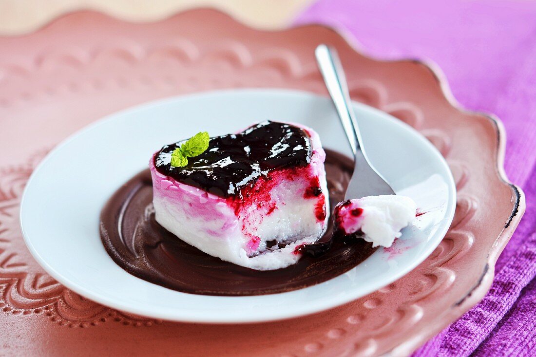 A heart shaped dessert with berry jam and chocolate cream